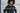 woman with afro wearing a black mineral wash hooded pullover sweatshirt with text over the image