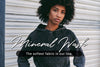 woman with afro wearing a black mineral wash hooded pullover sweatshirt with text over the image