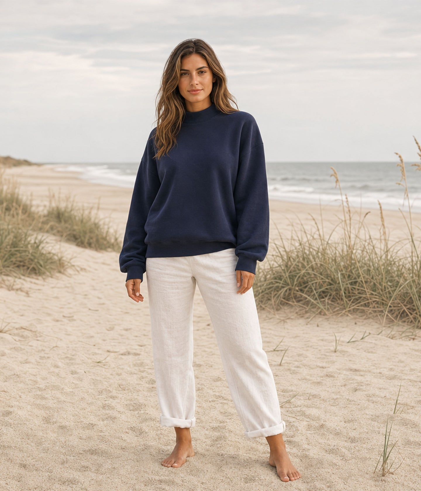 Independent Trading Co. IND280MOCK Women's Midweight Mockneck Sweatshirt in color Classic Navy on a woman standing on the beach