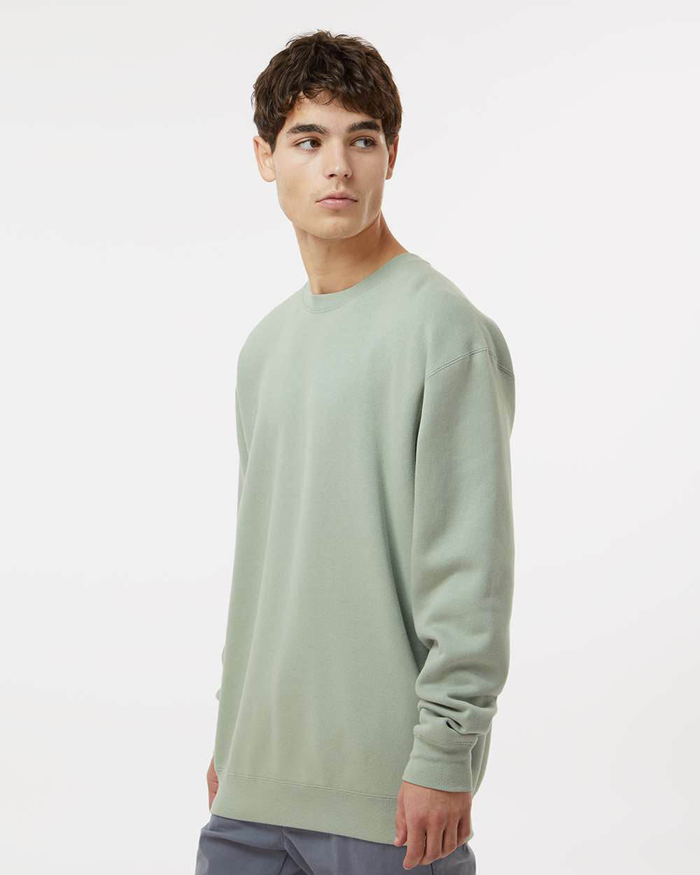 Man wearing a Dusty Sage color 10oz. Heavyweight Crew - Independent Trading Company
