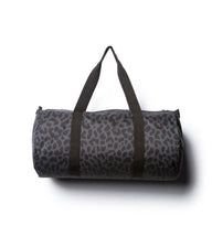 Day Tripper 29 Liter Duffle Bag made of durable polyester material with Nylon handles and removable shoulder strap in Black Cheetah.